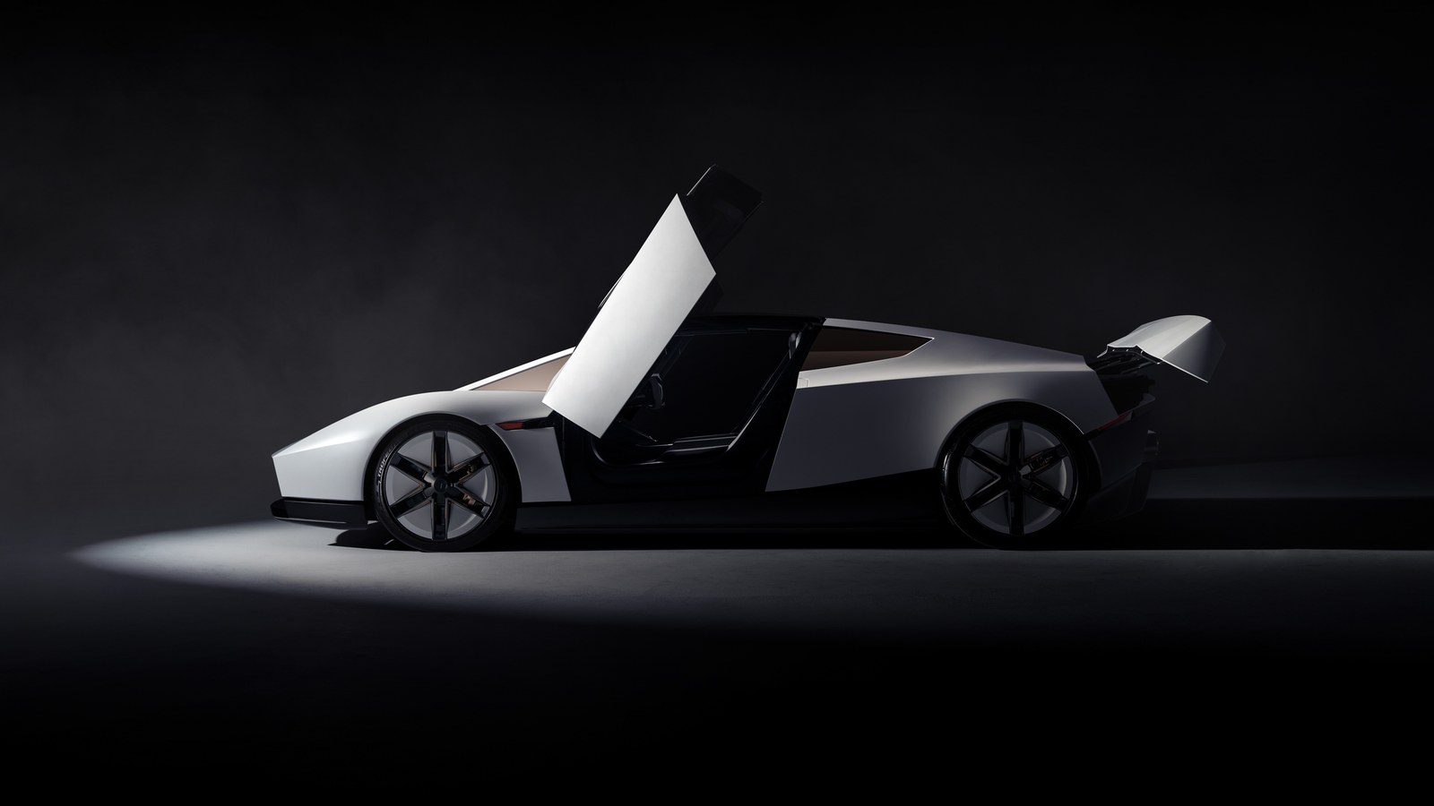 Le nouveau Tesla Roadster blanc vu de profil sur fond noir, porte en élytre ouverte et aileron arrière déployé